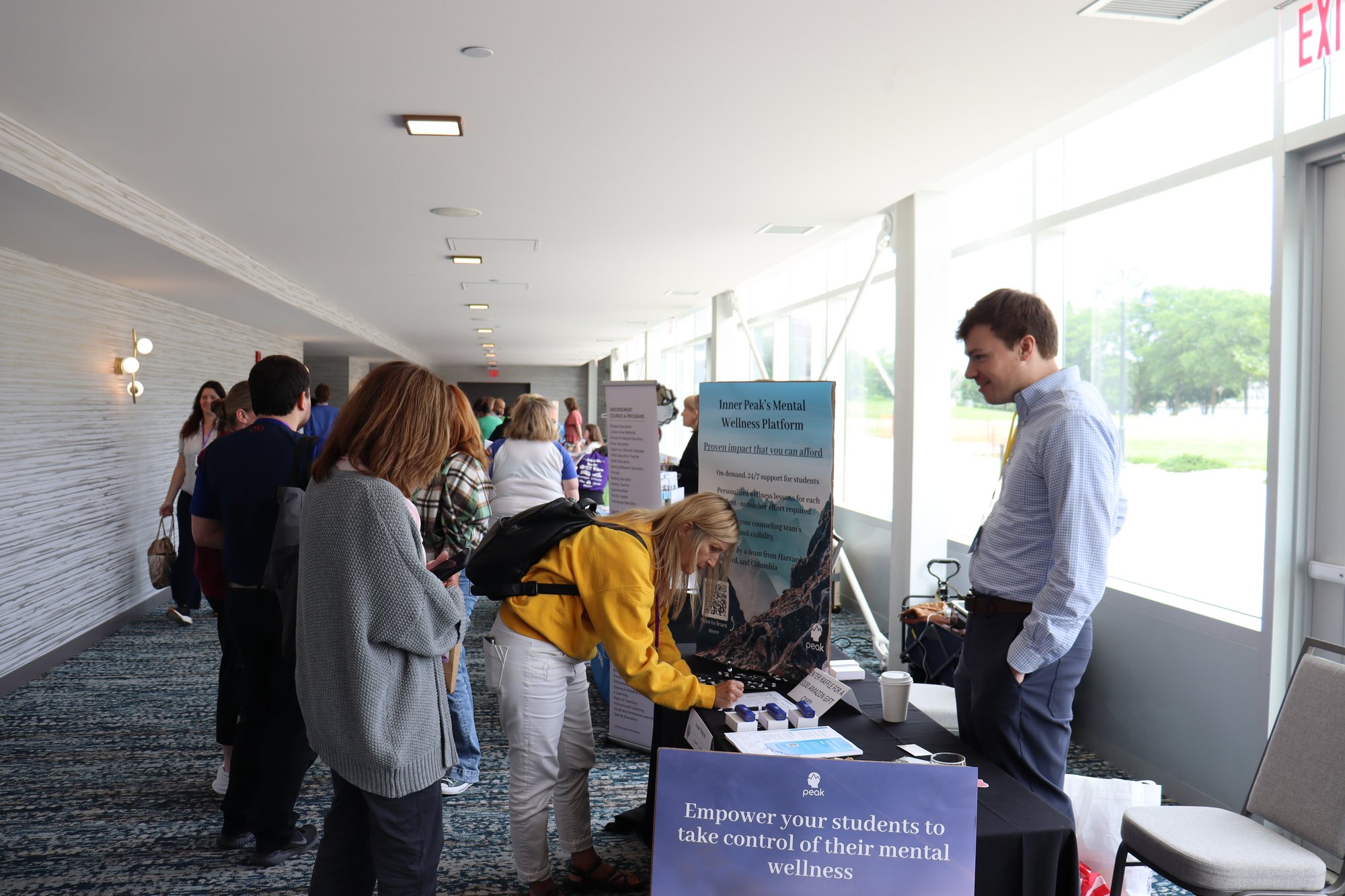 People talking with exhibitor